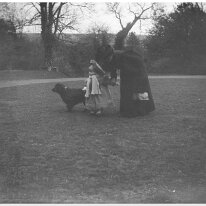 Lady with v. small child and dog Original caption: Lady with v. small child and dog